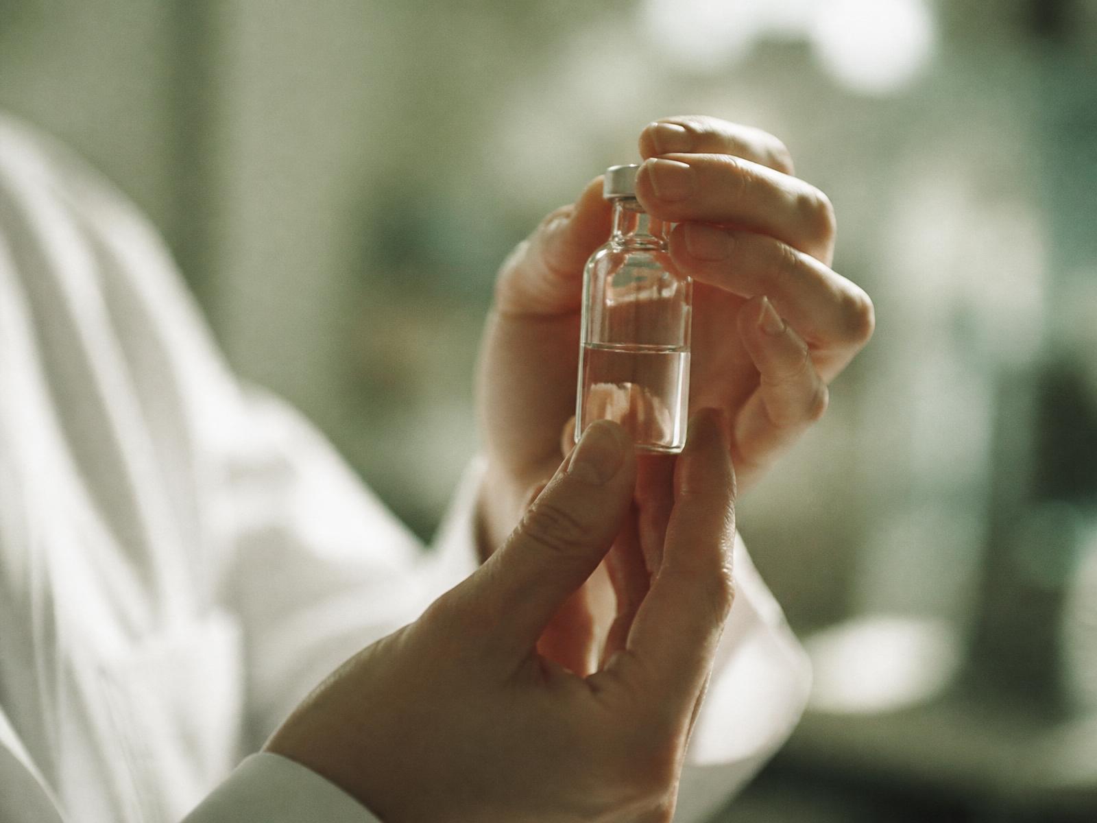 A researcher holding a laboratory vial